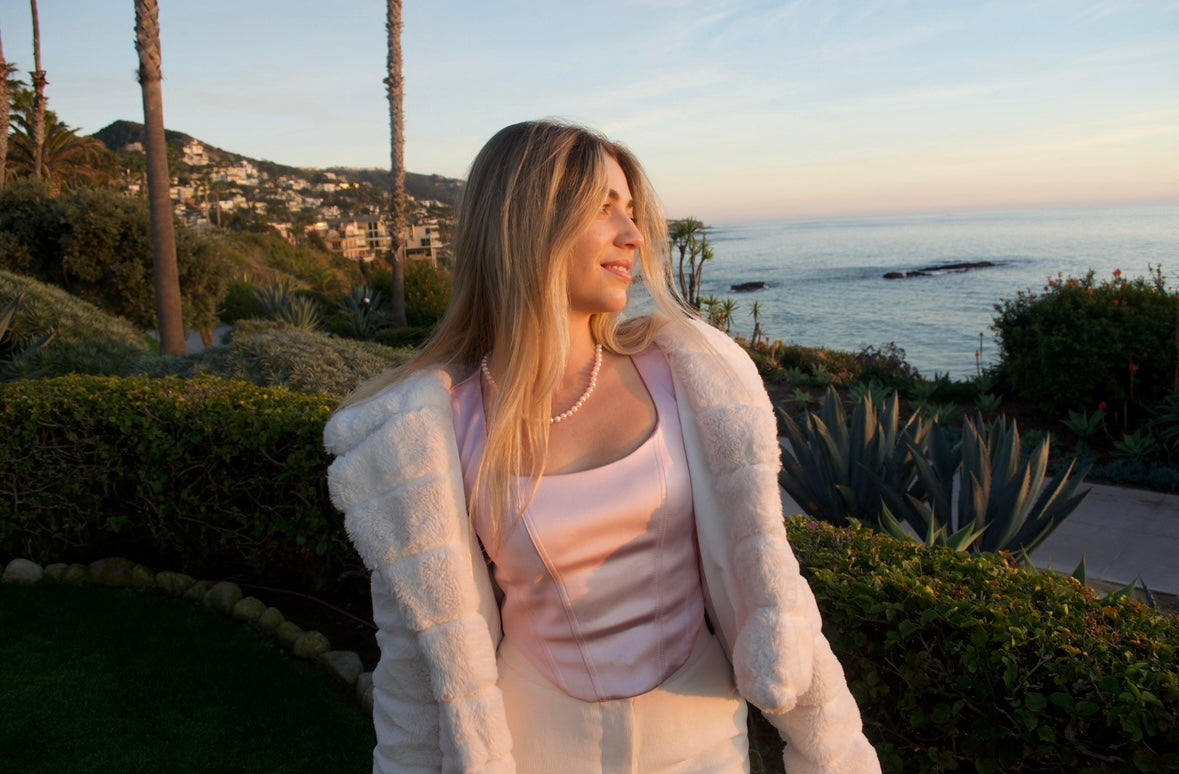 Madison Weir, founder of Mountainstead Publishing, overlooking the coast at sunset
