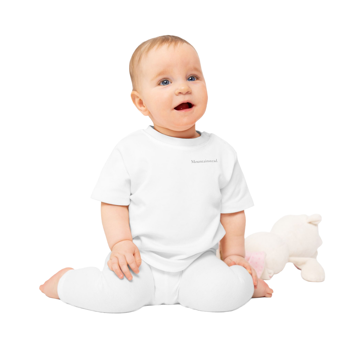 Transparent cutout of the exact Printify baby wearing the Rooted, Curious & Free T-shirt with toy